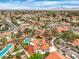 Panoramic aerial shot of a neighborhood showcasing multiple homes, many with swimming pools and green landscaping at 5757 Charles Holden Ct, Las Vegas, NV 89103