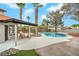 Inviting backyard features a covered patio, sparkling pool, and lush landscaping at 5757 Charles Holden Ct, Las Vegas, NV 89103