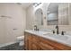 Well-lit bathroom showcasing a double sink vanity, quartz countertops, wood cabinets and modern fixtures at 5757 Charles Holden Ct, Las Vegas, NV 89103
