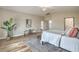 Bright primary bedroom with modern decor, a comfortable bed, and a cozy seating area, creating a relaxing retreat at 5757 Charles Holden Ct, Las Vegas, NV 89103
