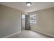 This bedroom offers neutral walls, carpeting, a window and features a closet and doorway for convenience and privacy at 5757 Charles Holden Ct, Las Vegas, NV 89103