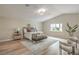 Inviting primary bedroom features a comfortable bed, stylish furnishings, and plenty of natural light from the large window at 5757 Charles Holden Ct, Las Vegas, NV 89103