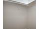 Walk-in closet showing hanging rod with white shelving in the background at 5757 Charles Holden Ct, Las Vegas, NV 89103