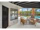 Relaxing covered patio with cozy seating and views of the backyard pool area at 5757 Charles Holden Ct, Las Vegas, NV 89103