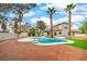 Backyard view showcasing a pool and palm trees, creating a relaxing and private outdoor space at 5757 Charles Holden Ct, Las Vegas, NV 89103