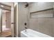 Contemporary shower and tub combination with gray tile surround and black fixtures, offering a sleek design at 5757 Charles Holden Ct, Las Vegas, NV 89103