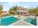 Spacious backyard featuring a pool, lounging chairs, built-in grill and lots of green space at 6315 Bellisima St, Las Vegas, NV 89118