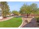 Lush backyard area featuring green artificial turf with desert landscaping at 6315 Bellisima St, Las Vegas, NV 89118