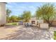 Expansive backyard featuring a built-in grill, pizza oven, fireplace, and ample seating, perfect for outdoor entertaining at 6315 Bellisima St, Las Vegas, NV 89118