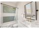 Bathroom featuring herringbone tile in shower with marble countertop and black framed mirror and fixtures at 6315 Bellisima St, Las Vegas, NV 89118