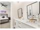 Bathroom featuring double sinks with marble countertops, gold hardware and black framed mirrors at 6315 Bellisima St, Las Vegas, NV 89118