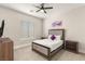 Bedroom featuring a cushioned headboard bed frame, bedside tables and window with blinds at 6315 Bellisima St, Las Vegas, NV 89118