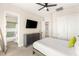 Bright bedroom featuring a ceiling fan, flatscreen television, closet, and adjoining bathroom with herringbone tile at 6315 Bellisima St, Las Vegas, NV 89118