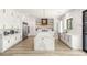 Bright, open kitchen featuring a large island, stainless steel appliances, and sleek white cabinetry at 6315 Bellisima St, Las Vegas, NV 89118