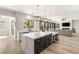 Open-concept kitchen with a marble island, bar seating, and a seamless flow to the living area and pool view at 6315 Bellisima St, Las Vegas, NV 89118