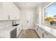 Bright kitchenette features white cabinetry, marble countertops, and a modern faucet at 6315 Bellisima St, Las Vegas, NV 89118