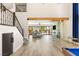 Open-concept interior showcasing a grand staircase, glass-enclosed wine storage, and living area at 6315 Bellisima St, Las Vegas, NV 89118