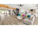 Spacious living room area with an open layout flowing into the kitchen, wine storage, and staircase at 6315 Bellisima St, Las Vegas, NV 89118