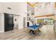 Expansive living room with a soaring ceiling, billiard table, staircase, and modern flooring at 6315 Bellisima St, Las Vegas, NV 89118