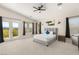 Bright main bedroom features a king bed, balcony access and mountain views at 6315 Bellisima St, Las Vegas, NV 89118