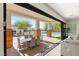 A stylish patio with an outdoor dining area and a pool, seamlessly connected to the indoors at 6315 Bellisima St, Las Vegas, NV 89118