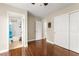 Bedroom with hardwood floors, two closets, and an ensuite bathroom, providing convenience at 6488 Bentley Wood Ct, Las Vegas, NV 89130