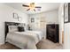 Bedroom with a ceiling fan, window and a queen-size bed with comfortable bedding at 6488 Bentley Wood Ct, Las Vegas, NV 89130