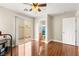 Bedroom with hardwood flooring, ceiling fan, and sliding door with access to outdoor patio area at 6488 Bentley Wood Ct, Las Vegas, NV 89130