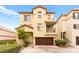 Lovely home showcasing a two-car garage, charming balconies, and tidy landscaping at 6488 Bentley Wood Ct, Las Vegas, NV 89130