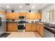Well-equipped kitchen featuring stainless steel appliances and light wood cabinets at 6488 Bentley Wood Ct, Las Vegas, NV 89130