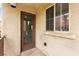 An inviting porch with glass door, side window, and neutral stucco at 6488 Bentley Wood Ct, Las Vegas, NV 89130