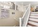 Elegant staircase with white banister and wood-trimmed steps to the second level at 6488 Bentley Wood Ct, Las Vegas, NV 89130
