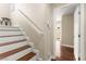 Bright staircase featuring hardwood treads, white risers and handrail, leading to the upper level at 6488 Bentley Wood Ct, Las Vegas, NV 89130