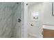 Updated bathroom featuring a marble shower and a new vanity with a modern sink at 663 D Ave, Boulder City, NV 89005