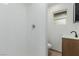 Bathroom featuring a tiled shower, modern vanity, and neutral-toned flooring at 663 D Ave, Boulder City, NV 89005