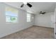 Bright bedroom with large windows, ceiling fan, and neutral carpet at 663 D Ave, Boulder City, NV 89005