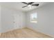 Well-lit bedroom featuring light wood floors, neutral walls, and ceiling fan at 663 D Ave, Boulder City, NV 89005