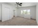 Carpeted bedroom with closet, ceiling fan and bright natural light from multiple windows at 663 D Ave, Boulder City, NV 89005