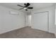 Bedroom with neutral carpet, ceiling fan, AC unit and closet at 663 D Ave, Boulder City, NV 89005