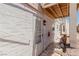 White painted home featuring a glass door, rocks, and outdoor lighting at 663 D Ave, Boulder City, NV 89005