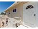 A close up on a house entrance with a wooden porch and decorative white door at 663 D Ave, Boulder City, NV 89005