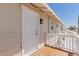 A house entrance featuring a freshly painted white door and wood porch at 663 D Ave, Boulder City, NV 89005