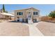This home features fresh exterior paint and inviting entryway stairs at 663 D Ave, Boulder City, NV 89005