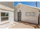 Exterior of a white garage with security door, gravel, and window at 663 D Ave, Boulder City, NV 89005