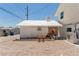 Exterior of a house featuring a detached garage and gravel landscaping at 663 D Ave, Boulder City, NV 89005