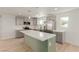 Modern kitchen with stainless steel appliances, gray cabinetry, and green kitchen island at 663 D Ave, Boulder City, NV 89005