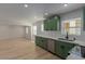Open-concept kitchen features modern finishes, wood flooring, and a window at 663 D Ave, Boulder City, NV 89005