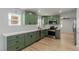 Newly renovated kitchen with stylish green cabinets and stainless steel appliances at 663 D Ave, Boulder City, NV 89005