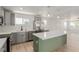 Well-appointed kitchen featuring stainless steel appliances, gray cabinets, and kitchen island at 663 D Ave, Boulder City, NV 89005