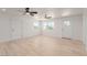 A large, bright living room with neutral paint, new flooring and a ceiling fan at 663 D Ave, Boulder City, NV 89005
